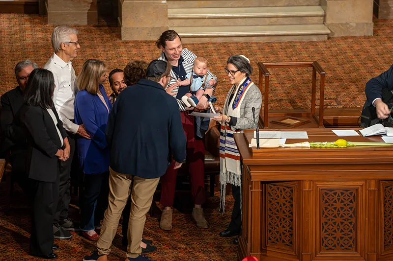 Family gathers with the Rabbi for a B'rit Ceremony