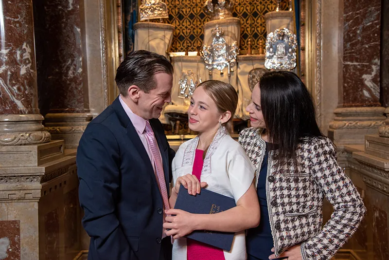 smily girl with her parents at b'nai mitzvah