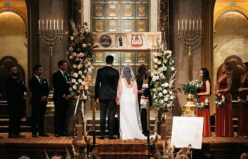 A Couple under a chuppah for their wedding.