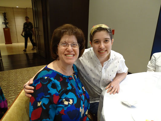 two people at tables for Pride Shabbat